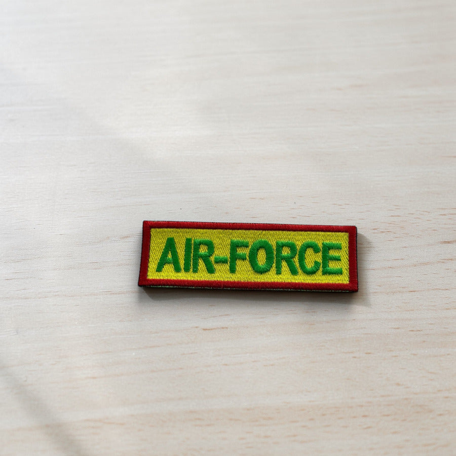 Rectangular patch with 'AIR FORCE' text on a light wooden surface