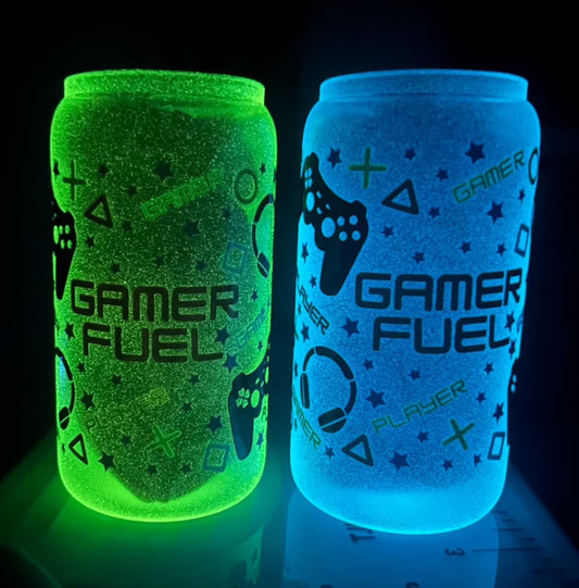 Two 16oz glass cans with “Gamer Fuel” and miscellaneous gaming icons on them. The one on the left is glowing green, and the one on the right is glowing blue