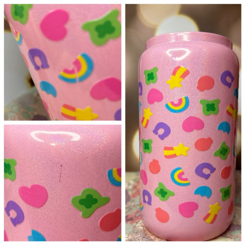 Up close images of a pink sparkly tumbler, with the charm style decalsl on it. First photo shows a crack in a rainbow, second one shows a small scratch where the pink sparkly coating was scratched off, and third photo shows that the decal was applied upside down. This is considered a "second quality" cup