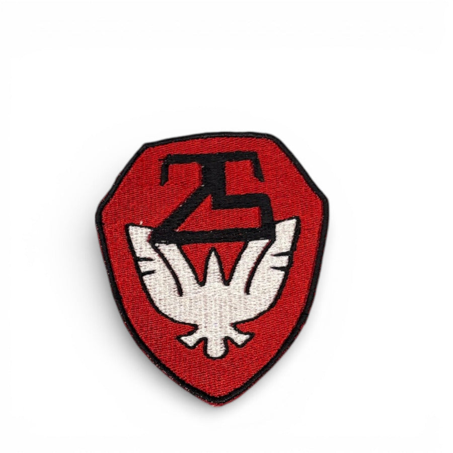 Red shield-shaped patch with a black symbol and white emblem on a white background