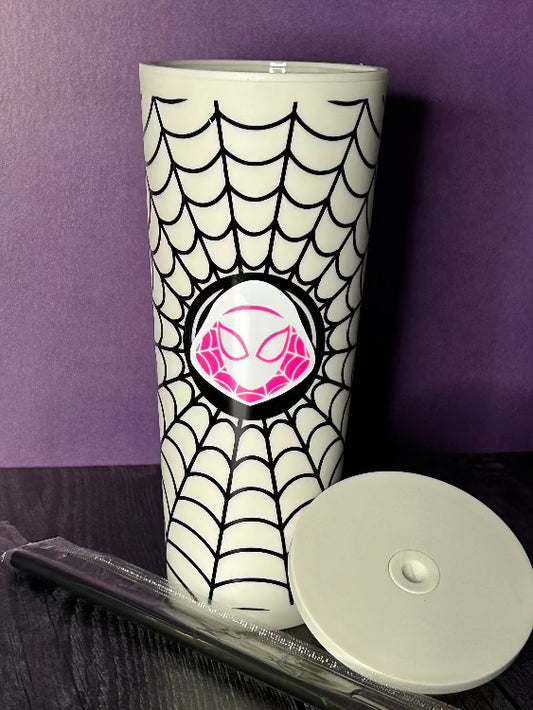 24oz matte white tumbler, with black vinyl spiderweb decoration and in the center is a white and pink portrait of Gwen Stacy as Spider-Gwen. The hood, face and eyes are white and there is a small amount of pink outlining a spiderweb design on the inside of the hood and outlining the eye pieces.