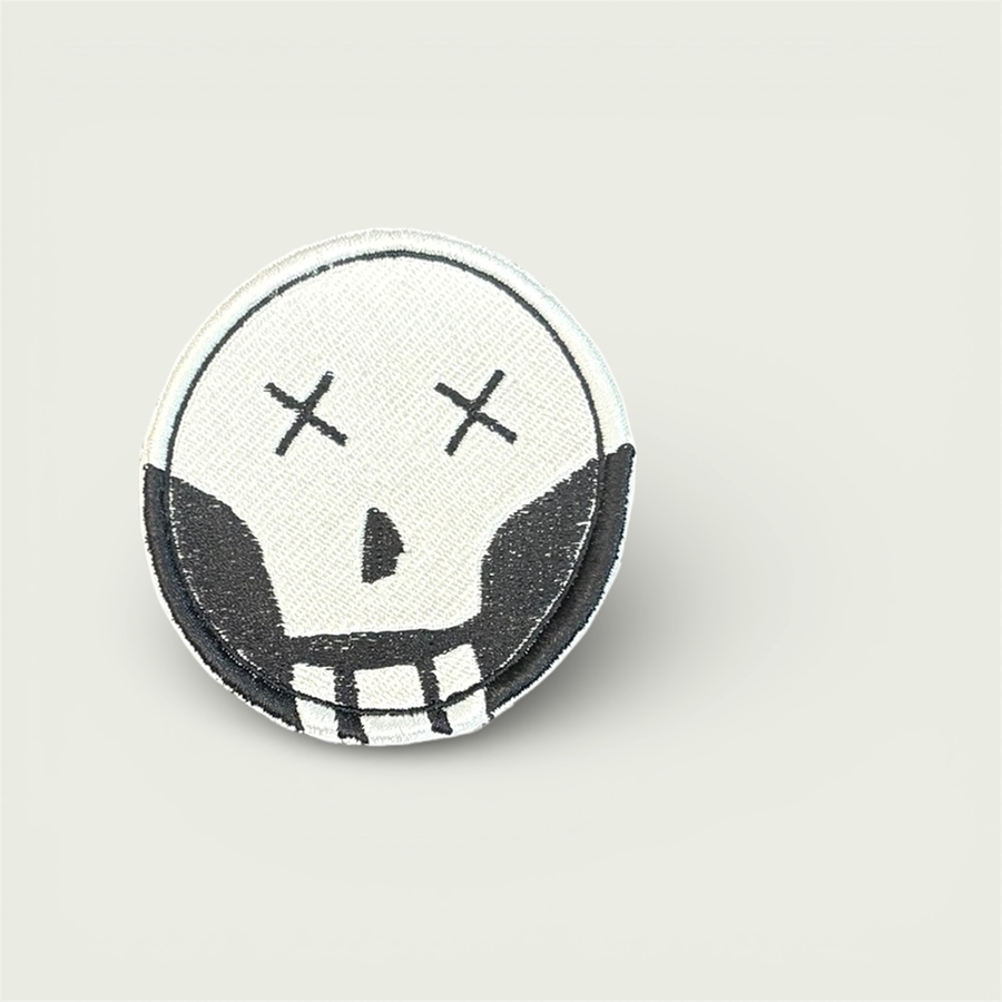 A stylized white skull with Xs across the eyes, with a black backdrop